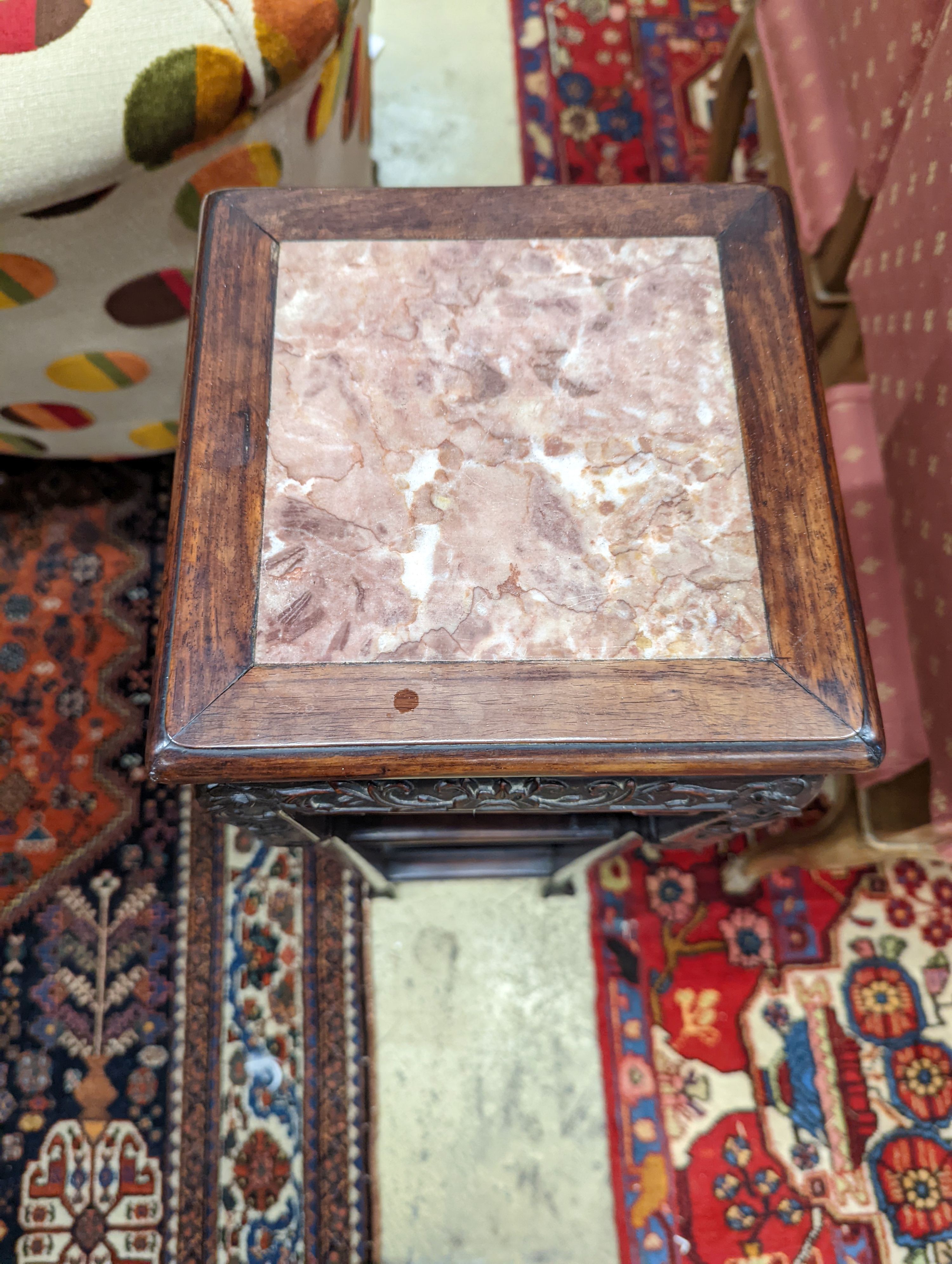 A Chinese carved hardwood three tier jardiniere stand, marble inset, width 22cm, depth 22cm, height 82cm